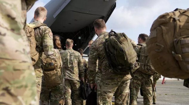 Фото:  AP Photo / Virginia Mayo Военные готовятся к посадке на военный самолет. Архивное фото